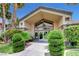 Inviting community building entrance framed by manicured landscaping and clear glass doors at 3360 Cactus Shadow St # 102, Las Vegas, NV 89129