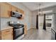 Modern kitchen dining area with stainless steel appliances and access to outdoor living at 3360 Cactus Shadow St # 102, Las Vegas, NV 89129