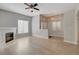 Bright living room features a fireplace, light wood flooring, and a ceiling fan at 3360 Cactus Shadow St # 102, Las Vegas, NV 89129