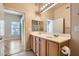 Bathroom shows double sinks, vanity lighting, and provides access to the bedroom at 3451 Desert Cliff St # 103, Las Vegas, NV 89129