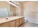 Bright bathroom with double sinks, granite counters, tile floors, and a tub/shower combo at 3451 Desert Cliff St # 103, Las Vegas, NV 89129