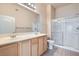 Bathroom boasts double sinks, a large mirror, vanity lighting and a glass door shower at 3451 Desert Cliff St # 103, Las Vegas, NV 89129