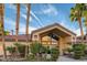 Exterior view of the clubhouse framed by palm trees on a sunny day at 3451 Desert Cliff St # 103, Las Vegas, NV 89129