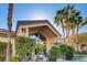 Exterior view of the clubhouse framed by palm trees and blue skies at 3451 Desert Cliff St # 103, Las Vegas, NV 89129