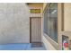 Exterior entrance featuring a beige door, textured walls, and a small window above the door at 3451 Desert Cliff St # 103, Las Vegas, NV 89129