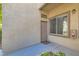 Exterior entrance featuring a beige door, textured walls, and a small window above the door at 3451 Desert Cliff St # 103, Las Vegas, NV 89129