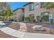 Exterior view of a condo building featuring stairs, desert landscaping, and pet waste station at 3451 Desert Cliff St # 103, Las Vegas, NV 89129