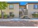 Exterior view of a well-maintained condo building featuring a staircase and desert landscaping at 3451 Desert Cliff St # 103, Las Vegas, NV 89129