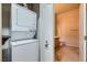 View of a stacked washer and dryer with access to the nearby bathroom at 3451 Desert Cliff St # 103, Las Vegas, NV 89129