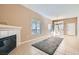 Bright living room featuring tile floors, a fireplace, and large windows with natural light at 3451 Desert Cliff St # 103, Las Vegas, NV 89129