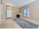 Cozy living room featuring tile floors, a fireplace, neutral paint, and a large window at 3451 Desert Cliff St # 103, Las Vegas, NV 89129