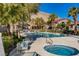 Community pool and hot tub with lounge chairs and mountain views on a sunny day at 3451 Desert Cliff St # 103, Las Vegas, NV 89129