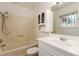 Cozy bathroom with a shower-tub combo, decorative cabinet, and single sink vanity at 3730 Greenwood Dr, Las Vegas, NV 89103