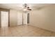 This bedroom features neutral paint, tile flooring, ceiling fan, and closet at 3730 Greenwood Dr, Las Vegas, NV 89103