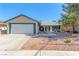 Charming single-story home featuring a well-manicured yard, attached two-car garage, and welcoming front entrance at 3730 Greenwood Dr, Las Vegas, NV 89103