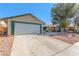 Exterior view showcasing the home's driveway, two-car garage, and low-maintenance landscaping in a bright, sunny setting at 3730 Greenwood Dr, Las Vegas, NV 89103