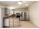 Kitchen features stainless appliances, grey cabinets and a breakfast bar, and tile floors at 3730 Greenwood Dr, Las Vegas, NV 89103