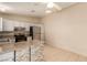 Kitchen with tile flooring, stone-accented breakfast bar, stainless steel appliances, and grey cabinets at 3730 Greenwood Dr, Las Vegas, NV 89103