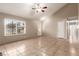 Spacious living room with a large window, vaulted ceiling, neutral walls, and tile flooring, ready for personalization at 3730 Greenwood Dr, Las Vegas, NV 89103