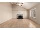 Bright living room featuring a fireplace, large windows, vaulted ceiling, and neutral tones for versatile décor at 3730 Greenwood Dr, Las Vegas, NV 89103