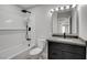 Modern bathroom features a tiled shower/tub, a sleek vanity, and contemporary fixtures at 3998 Foxgrove Dr, Las Vegas, NV 89147