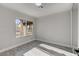 Bedroom featuring laminate floors, white trim, gray walls, and neighborhood view at 3998 Foxgrove Dr, Las Vegas, NV 89147