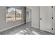 Bedroom with new gray wood flooring and a large window with neighborhood views at 3998 Foxgrove Dr, Las Vegas, NV 89147