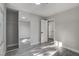 Bedroom featuring modern gray walls, laminate floors, and a mirrored closet at 3998 Foxgrove Dr, Las Vegas, NV 89147