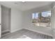 Bedroom with gray walls, laminate floors, and bright window and closet at 3998 Foxgrove Dr, Las Vegas, NV 89147