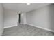 Light and airy bedroom features grey wood-look flooring at 3998 Foxgrove Dr, Las Vegas, NV 89147