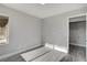 Bright bedroom featuring laminate floors, white trim, and gray walls with view to laundry room at 3998 Foxgrove Dr, Las Vegas, NV 89147