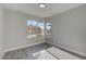 Sunlit bedroom with large window, gray walls, laminate floors, and white trim at 3998 Foxgrove Dr, Las Vegas, NV 89147