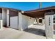 Contemporary house with attached garage, carport and desert landscaping with red and white rock at 3998 Foxgrove Dr, Las Vegas, NV 89147