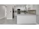 Well-lit kitchen with stainless steel appliances, gray countertops, and white cabinets at 3998 Foxgrove Dr, Las Vegas, NV 89147