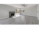 Inviting living room features a brick fireplace, ceiling fan, luxury vinyl plank flooring and natural light at 3998 Foxgrove Dr, Las Vegas, NV 89147