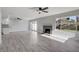 Bright living room with fireplace, sliding glass doors, ceiling fan, and luxury vinyl plank flooring at 3998 Foxgrove Dr, Las Vegas, NV 89147