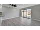 Living room features luxury vinyl plank flooring, modern ceiling fan, and sliding glass doors to the backyard at 3998 Foxgrove Dr, Las Vegas, NV 89147