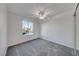 Bright and airy bedroom with carpeting, ceiling fan, and a bright window at 402 Bell Ave, Henderson, NV 89015