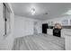 Modern kitchen with white cabinets, stainless steel appliances, and stylish gray flooring at 402 Bell Ave, Henderson, NV 89015