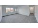 Bright and airy living room with plush carpeting, a large window, and fresh paint at 402 Bell Ave, Henderson, NV 89015