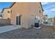 Property backyard featuring a small patio, rock ground cover, and stucco home exterior at 4228 Hickman Ct, Las Vegas, NV 89129