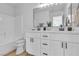 A modern bathroom with double sinks, white cabinetry, and a shower-tub combination at 4228 Hickman Ct, Las Vegas, NV 89129