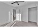 A well lit bedroom featuring plush carpeting, a ceiling fan, and a sliding door closet at 4228 Hickman Ct, Las Vegas, NV 89129