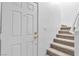 Welcoming entryway featuring a staircase and a white front door at 4228 Hickman Ct, Las Vegas, NV 89129