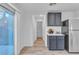 Bright kitchen with sliding door and stainless steel refrigerator at 4228 Hickman Ct, Las Vegas, NV 89129