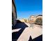 Paver patio in backyard with a table and mature landscaping at 4562 White Cap Mill St, Las Vegas, NV 89147