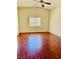 Bedroom boasts wood-look flooring, a vaulted ceiling, a ceiling fan and a window at 4562 White Cap Mill St, Las Vegas, NV 89147