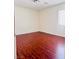 Bedroom with hardwood flooring and natural light coming from a window at 4562 White Cap Mill St, Las Vegas, NV 89147