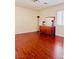 Bedroom with hard wood flooring, a wooden dresser with mirror, and natural light at 4562 White Cap Mill St, Las Vegas, NV 89147