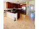 Modern kitchen with stainless steel appliances, granite counters, and tile flooring at 4562 White Cap Mill St, Las Vegas, NV 89147